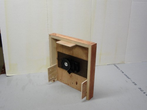 Clock movement mounted to a plywood frame