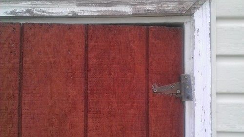 Poorly installed hinges on old shed door