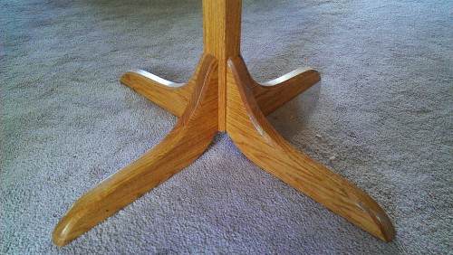 Coat rack base features curved tapering legs