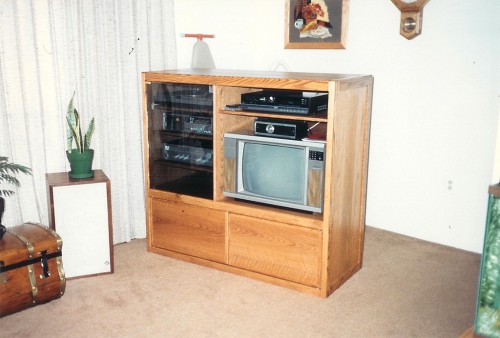 Entertainment center housing a 1980's era TV and stereo system