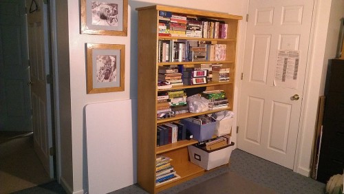 The bookshelf has migrated to the basement office for general purpose storage