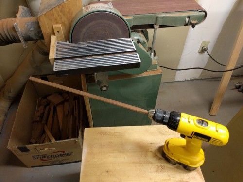 Blank mounted in drill is rough-rounded with disk sander