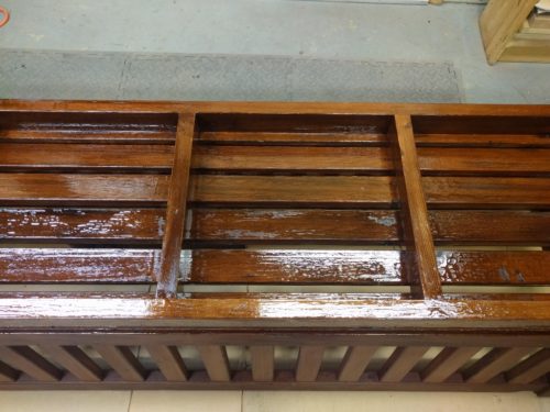 Close-up of penetrating epoxy applied to underside of bench