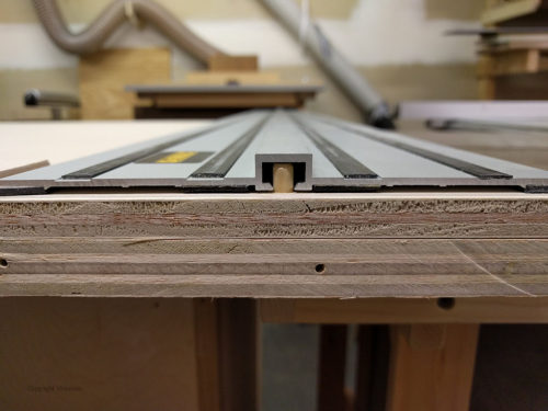 Close-up view shows how track slot fits snugly against the 1/4" alignment dowels