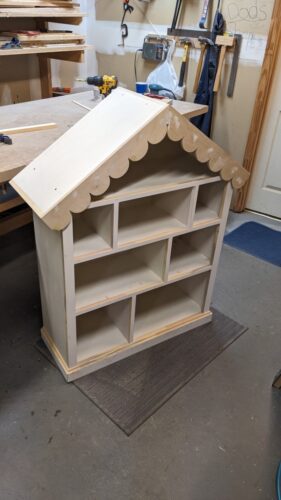 Nail holes in completed bookcase filled with wood putty